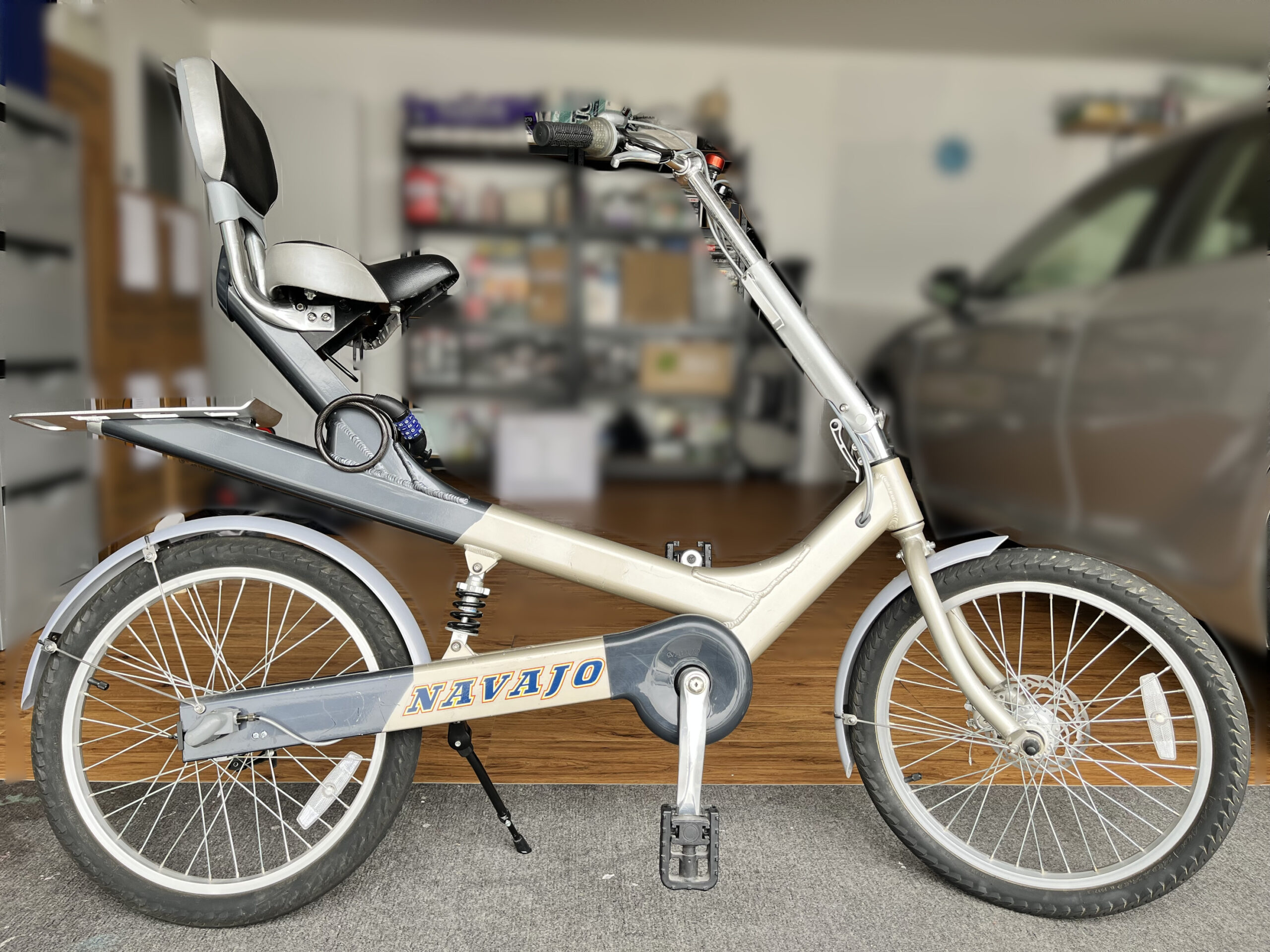 Navajo bicycle with a backrest seat, rear shock absorber and 3-speed hub gear, parked in a garage